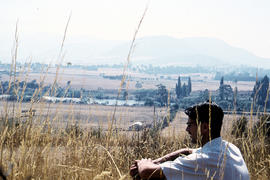 Man sitting in long grass at Plenty