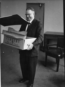 Man holding carton with Cadbury logo on side