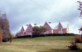 View of Clifton Priory and powerlines across front lawn