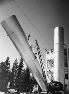 Cranes lifting cylinders