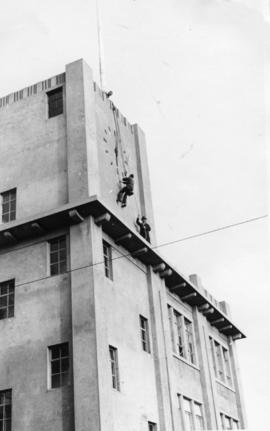 Employees fixing clock