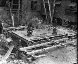 Workers assembling base of furnace jacket at E.Z. Co. Zinc Works