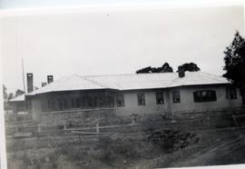 Black and white photograph of stone and render house