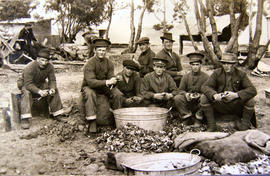 Men peeling potatoes